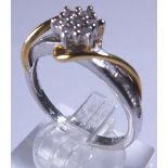 9 CT DIAMOND FLOWER RING. 9 ct gold and