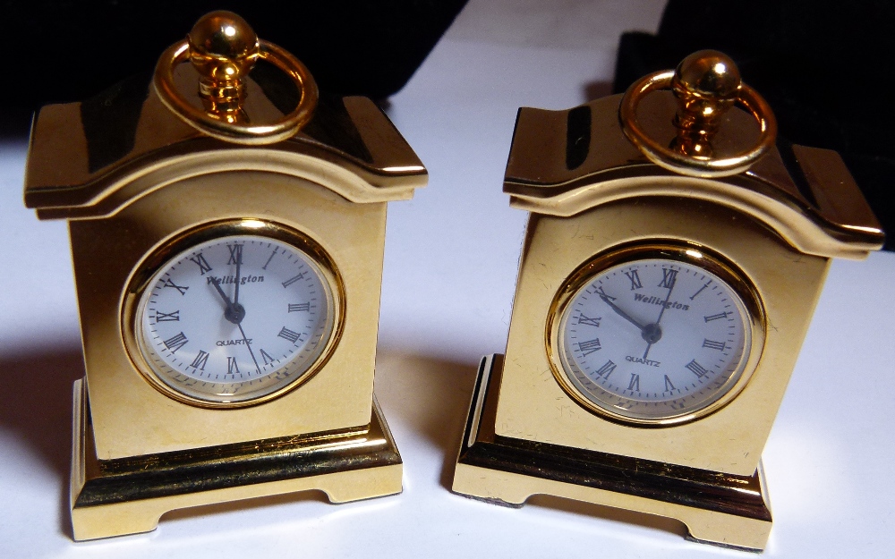 CASED CLOCKS. Two miniature clocks in ca