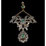 Emerald and paste set pendant, ornate openwork design in white metal testing as silver with yellow