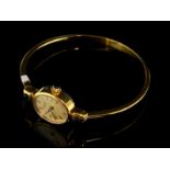 *Ladies' Raymond Weil bangle watch, oval dial with Roman numerals, gold plated case and bracelet,