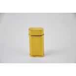 A Cartier yellow metal cigarette lighter in ribbed design, no. 34944