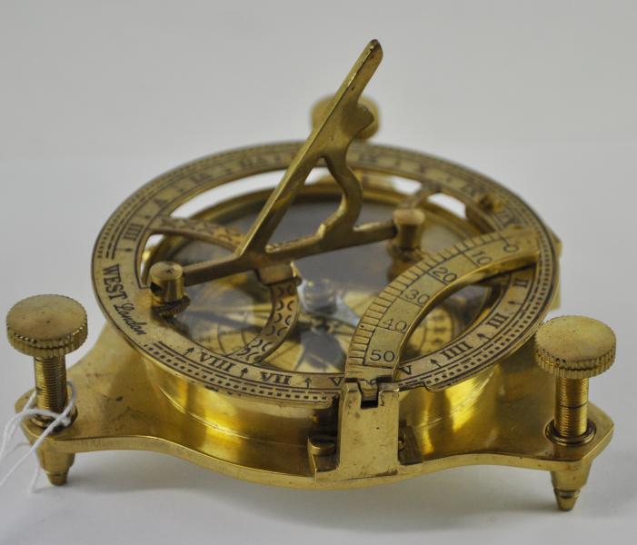 A brass combined compass and sun dial, with three adjustable feet, marked West, London, the dial 9cm - Image 2 of 2