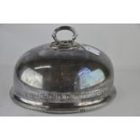 A silver plated domed meat cover with looped twig handle, beaded rims and Greek key engraving,