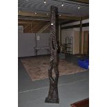 *A modern carved wooded abstract sculpture, 207cm tall.