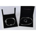 Two silver Pandora bracelets and a Pandora ring