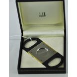 A Dunhill brushed stainless steel cigar cutter with gilt edges and screws, model number PA5250, in