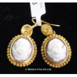 Pair of cameo drop earrings, oval cameo depicting the face of a cherub, mounted in yellow metal