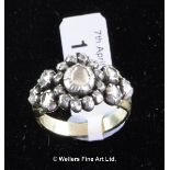 Diamond cluster ring, rose cut diamonds mounted in white metal tested as silver, on a yellow metal