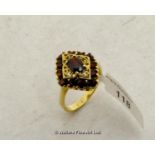 Garnet cluster ring mounted in yellow metal stamped and tested as 18ct, ring size O