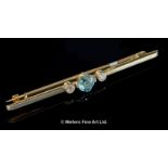 Zircon and diamond bar brooch, central blue zircon claw set with a rubover set diamond to each side,