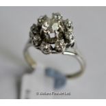 Diamond cluster ring, central old cut diamond weighing an estimated 0.65ct, surrounded by a