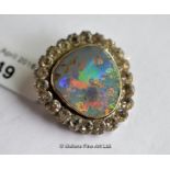 Opal brooch, rubover set opal in yellow metal testing as 14ct, with a surround of white stones