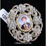 Oval enamel brooch, central enamel portrait of a young man, with an ornate openwork surround with