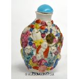 A Chinese famille rose snuff bottle relief moulded with boys, dragons and cloud bands, 8cm h
