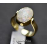 Opal ring, oval cabochon opal rubover set in 18ct yellow gold, 14 x 11mm, ring size Q