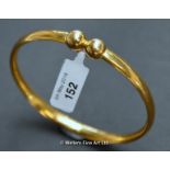 Yellow metal plain court bangle with double sphere centre, tested as 18ct or higher, weight 11.4