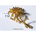 Foliate design brooch set with sapphires, in yellow metal tested as 18ct, gross weight 9.8 grams