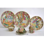 A group of Chinese famille rose wares comprising two plates, a smaller example, a cup; together with