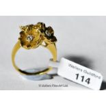 Diamond set dress ring, three flower clusters each set with a diamond, in yellow metal stamped as