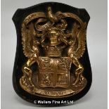 A bronze coat-of-arms for the Sinclair family, mounted on an ebonised oak shield, the shield stamped