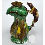 A majolica lidded hunting jug, the lid moulded with a recumbent hare, the handle formed as a dog,