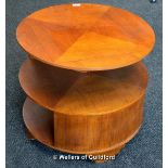 An Art Deco circular walnut book table with quarter veneered top above two tiers, raised on