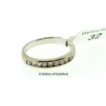 Diamond half eternity ring, nine round brilliant cut diamonds channel set in white metal stamped