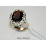 Garnet and diamond cluster ring, oval cut garnet with a surround of single cut diamonds illusion set