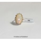 Opal and diamond cluster ring, oval cut opal weighing an estimated 7.09cts, with a surround of round