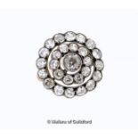 Diamond set circular brooch, central old cut diamond weighing an estimated 0.65ct, with two