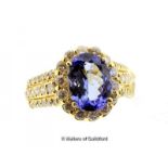 Tanzanite and diamond cluster ring, oval cut tanzanite weighing an estimated 3.30cts, with a