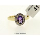 Amethyst and diamond ring, oval cut amethyst with a white metal surround set with four round