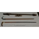 *An Indonesian wooden blow pipe carved as a dragon, with darts, 101cm; a Swiss walking cane with