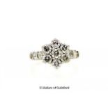 Diamond cluster ring, seven round brilliant cut diamonds in a flower design, with two further