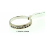 Diamond half eternity ring, nine round brilliant cut diamonds channel set in white metal stamped