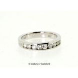 *Diamond half eternity ring, nine round brilliant cut diamonds channel set in white metal stamped