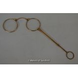 A pair of folding 9ct gold pince-nez with loop handle.