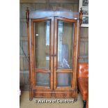 An early 20th Century French walnut library bookcase with arched top over two glazed doors enclosing