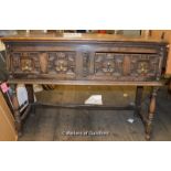 A late Georgian oak low dresser with plain top and two drawers with geometric carving, raised on