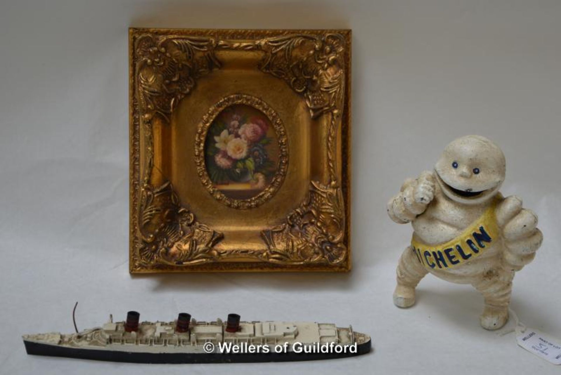 A Triang model of HMS Queen Mary; cast iron Michelin Man model; modern oil on board, still life with