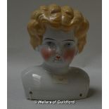 A 19th Century German glazed porcelain doll's head with blonde curls, painted blue eyes, rosy cheeks