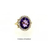 Amethyst and diamond cluster ring, oval cut amethyst surrounded by round cut diamonds, mounted in