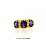 Amethyst and diamond three stone ring, three oval cut amethysts separated by two single cut diamonds