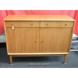 A Gordon Russell sideboard, 1950's, with two drawers over cupboard doors, decorated with incised
