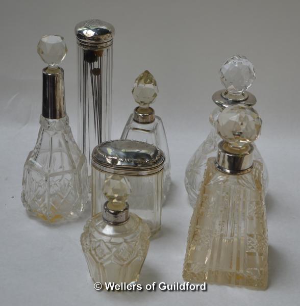 A group of seven glass scent bottles or jars including a tapering square example with cut corners (