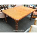 A Victorian mahogany extending dining table with one extra leaf, rounded corners, turned and
