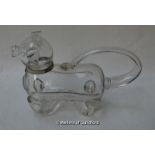 A 19th Century glass liqueur decanter in the form of a dog with white metal collar, 26cm long.