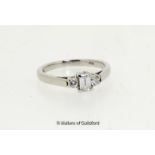 Three stone diamond ring, central crisscut diamond with a round brilliant cut diamond to either