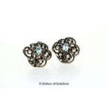 Aquamarine and diamond cluster ear studs, each earring set with a central oval cut aquamarine and