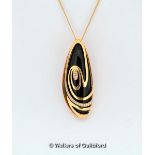 *Onyx and diamond pendant, an irregular oval onyx stone mounted in an 18ct rose gold swirl design,